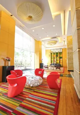 a living room with red chairs and a rug at 2 BR in Downtown BTS Chitlom BKK in Bangkok