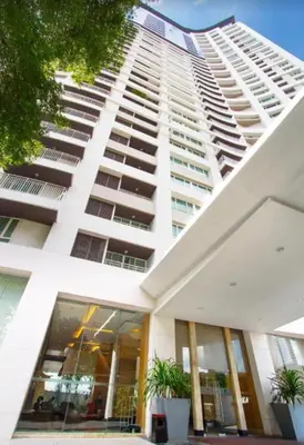 a tall white building with potted plants in front of it at 2 BR in Downtown BTS Chitlom BKK in Bangkok
