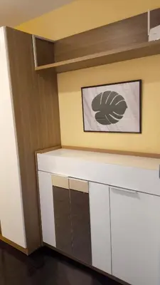 a kitchen with white cabinets and a picture on the wall at Silom room 1bedroom with 2 Kings bed for 4 persons in Bangkok