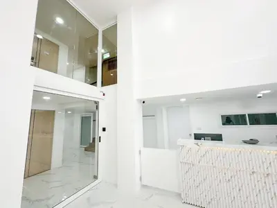 a bathroom with white walls and a white counter at H-Banaat Hotel near Yanhee Hospital in Bangkok
