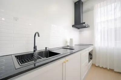 a kitchen with a sink and a counter top at SiS at Sathorn St Louis in Bangkok