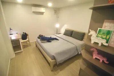 a bedroom with a bed with a stuffed animal on it at SiS at Sathorn St Louis in Bangkok