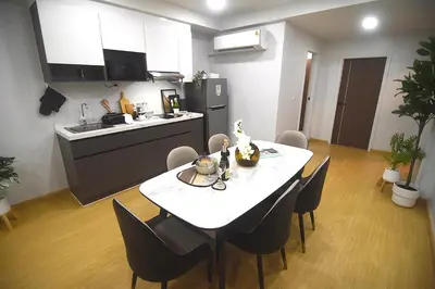 a kitchen and dining room with a table and chairs at SiS at Sathorn St Louis in Bangkok