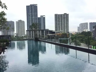 a large swimming pool in a city with tall buildings at BRAND New Sukhumvit Condo Cozy BTS in Bangkok