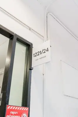 a sign for a set house on the side of a building at Lotus Bear House - 1BR Loft in Bangkok