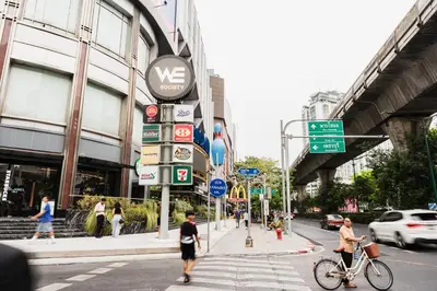 a group of people crossing a busy city street at Lotus Bear House - 1BR Loft in Bangkok