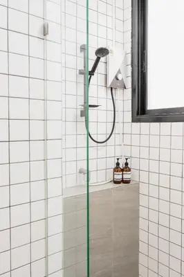 a shower with a shower head in a bathroom at Lotus Bear House - 1BR Loft in Bangkok