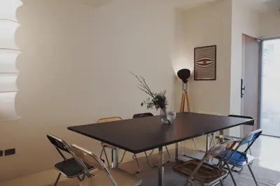 a dining room with a black table and chairs at Charming 3BR Design Loft in the Heart of Ari in Sathani Bang Su
