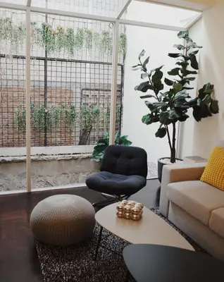 a living room with a couch and a chair and a table at Charming 3BR Design Loft in the Heart of Ari in Sathani Bang Su