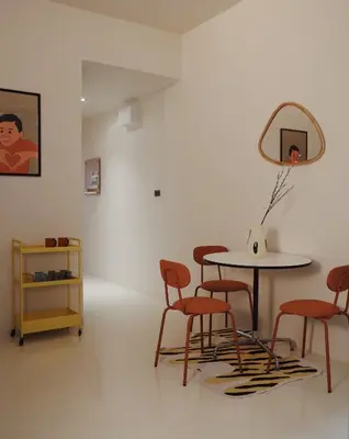 a room with a table and chairs and a mirror at Charming 3BR Design Loft in the Heart of Ari in Sathani Bang Su