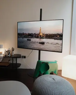 a living room with a flat screen tv on a wall at Charming 3BR Design Loft in the Heart of Ari in Sathani Bang Su