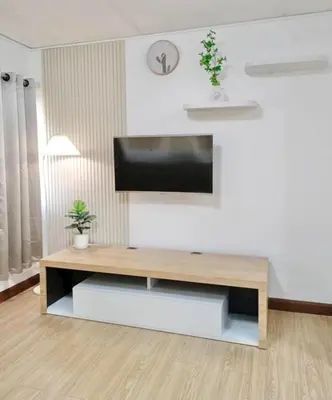 a living room with a flat screen tv on a wall at KANYA Popular Condo in Ban Bang Phang