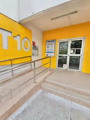 a yellow building with stairs in front of it at KANYA Popular Condo in Ban Bang Phang
