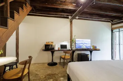 a bedroom with a bed and a desk with a computer at Baan Apak in Godown
