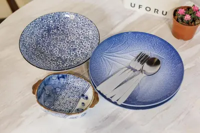 three blue plates and a fork and spoon on a table at Baan Apak in Godown