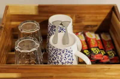 a wooden box with cups and cups and a tea set at Baan Apak in Godown