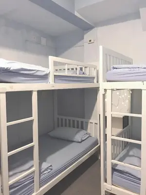 a room with three bunk beds in a room at 1sabai in Bangkok
