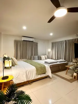 a bedroom with two beds and a ceiling fan at Serene Escape 2 mins from SRT Wat Samien Nari in Bangkok
