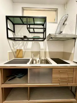 a kitchen with a sink and a mirror above it at Serene Escape 2 mins from SRT Wat Samien Nari in Bangkok