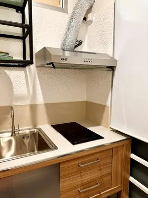 a small kitchen with a sink and a stove at Serene Escape 2 mins from SRT Wat Samien Nari in Bangkok