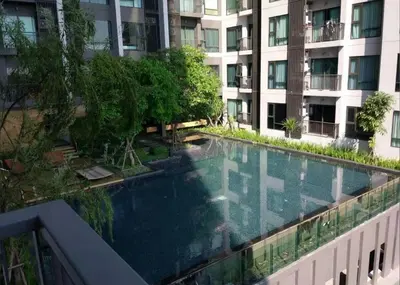 a swimming pool in the middle of a building at Beautiful condo, BTS Thonglor, 5mins by walking in Bangkok