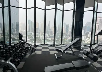 an empty gym with a view of a city at Beautiful condo, BTS Thonglor, 5mins by walking in Bangkok