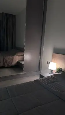 a bedroom with a mirror next to a bed at Beautiful condo, BTS Thonglor, 5mins by walking in Bangkok