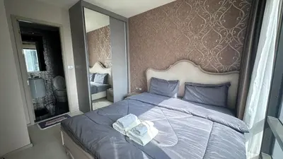 a bedroom with a large bed with a large mirror at Perfect condo, BTS Thong lo 5mins by walking in Bangkok