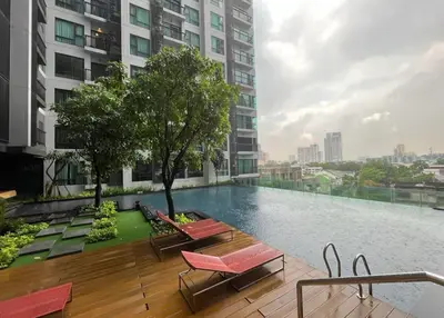 a swimming pool on the roof of a building at Perfect condo, BTS Thong lo 5mins by walking in Bangkok