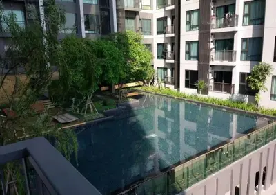 a swimming pool in the middle of a building at Perfect condo, BTS Thong lo 5mins by walking in Bangkok
