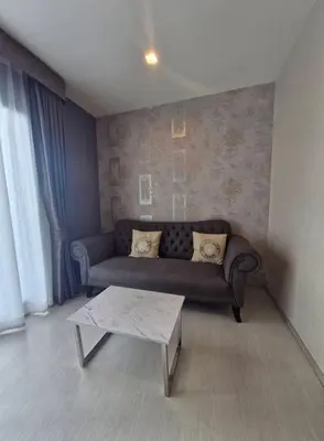 a living room with a couch and a coffee table at Perfect condo, BTS Thong lo 5mins by walking in Bangkok