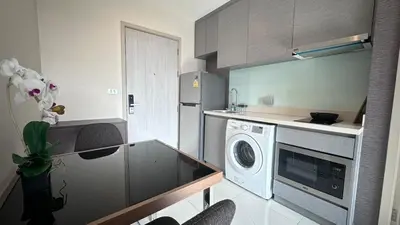 a small kitchen with a washer and dryer at Perfect condo, BTS Thong lo 5mins by walking in Bangkok