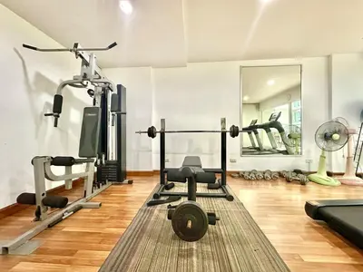 a gym with weights and other equipment in a room at Cosy Studio near BTS in Bangkok