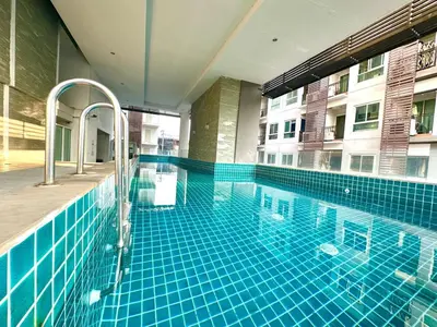 a swimming pool in the middle of a building at Cosy Studio near BTS in Bangkok