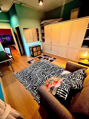a living room with a couch and a rug at Fab Rainbow Studio in Bangkok