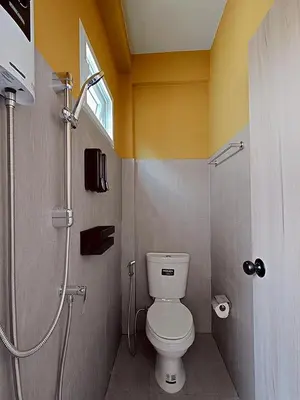 a bathroom with a toilet and a shower at Au Luna Bangkok Hostel in Bangkok