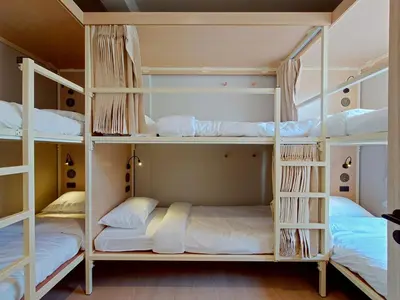 a bunk bed room with three bunk beds in it at Au Luna Bangkok Hostel in Bangkok