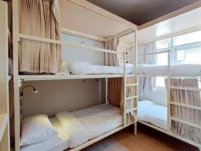 two bunk beds in a room with a window at Au Luna Bangkok Hostel in Bangkok