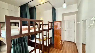 a bedroom with two bunk beds and a mirror at Les Fleurs Bangkok Hostel in Bangkok