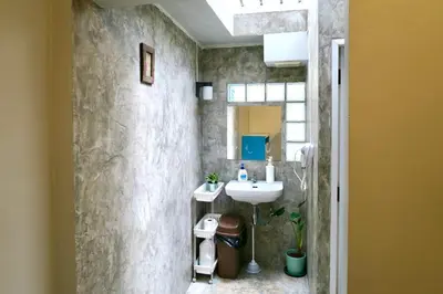 a bathroom with a sink and a mirror at Les Fleurs Bangkok Hostel in Bangkok