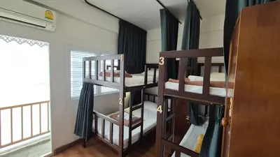 a room with three bunk beds and a window at Les Fleurs Bangkok Hostel in Bangkok