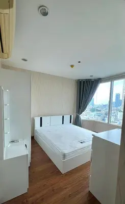 a white bedroom with a large bed and a window at Room near Iconsiam 2km in Bangkok