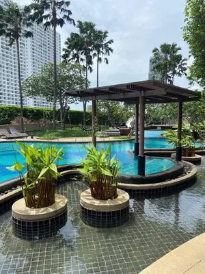 a swimming pool with a pavilion with plants in it at Room near Iconsiam 2km in Bangkok