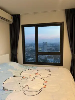 a bed in a room with a large window at 1BR Free pool&gym fast WIFI Airport Link in Sathani Ban Hua Mak