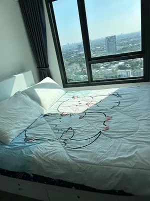 a bed in a room with a large window at 1BR Free pool&gym fast WIFI Airport Link in Sathani Ban Hua Mak