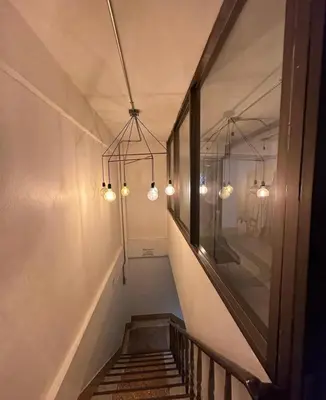 a stairway with lights hanging from the ceiling at 42 Guest House in Bangkok