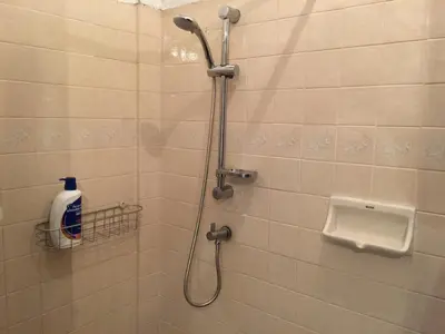 a bathroom with a shower with a toilet and a sink at 42 Guest House in Bangkok