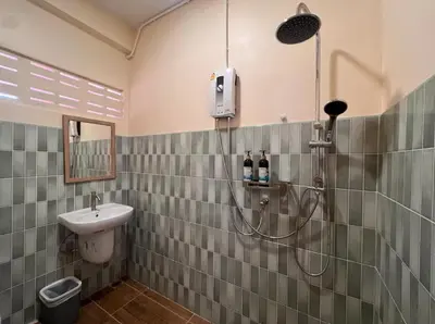 a bathroom with a shower and a sink at Papaya House Bangkok - Wat Arun in Bangkok Noi