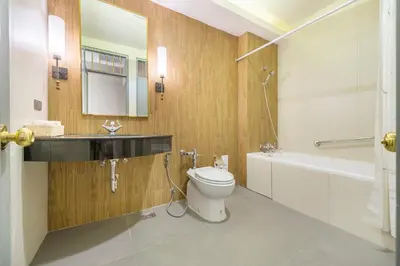 a bathroom with a toilet and a sink and a tub at Royal Rattanakosin Hotel - Near Grand Palace & Khaosan Road in Bangkok