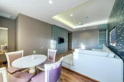 a living room with a couch and a table at Royal Rattanakosin Hotel - Near Grand Palace & Khaosan Road in Bangkok